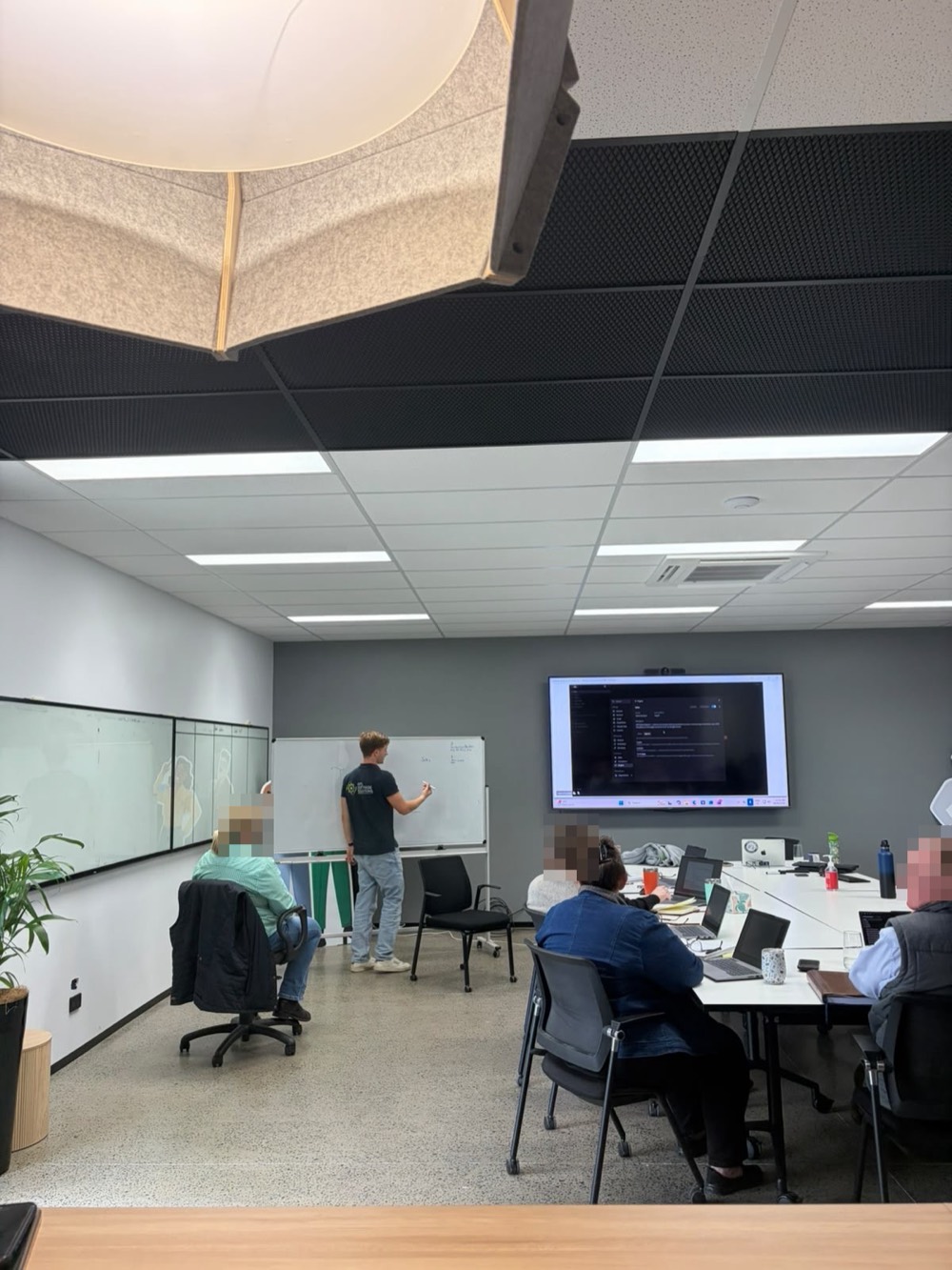 Adam at a whiteboard in a client training room